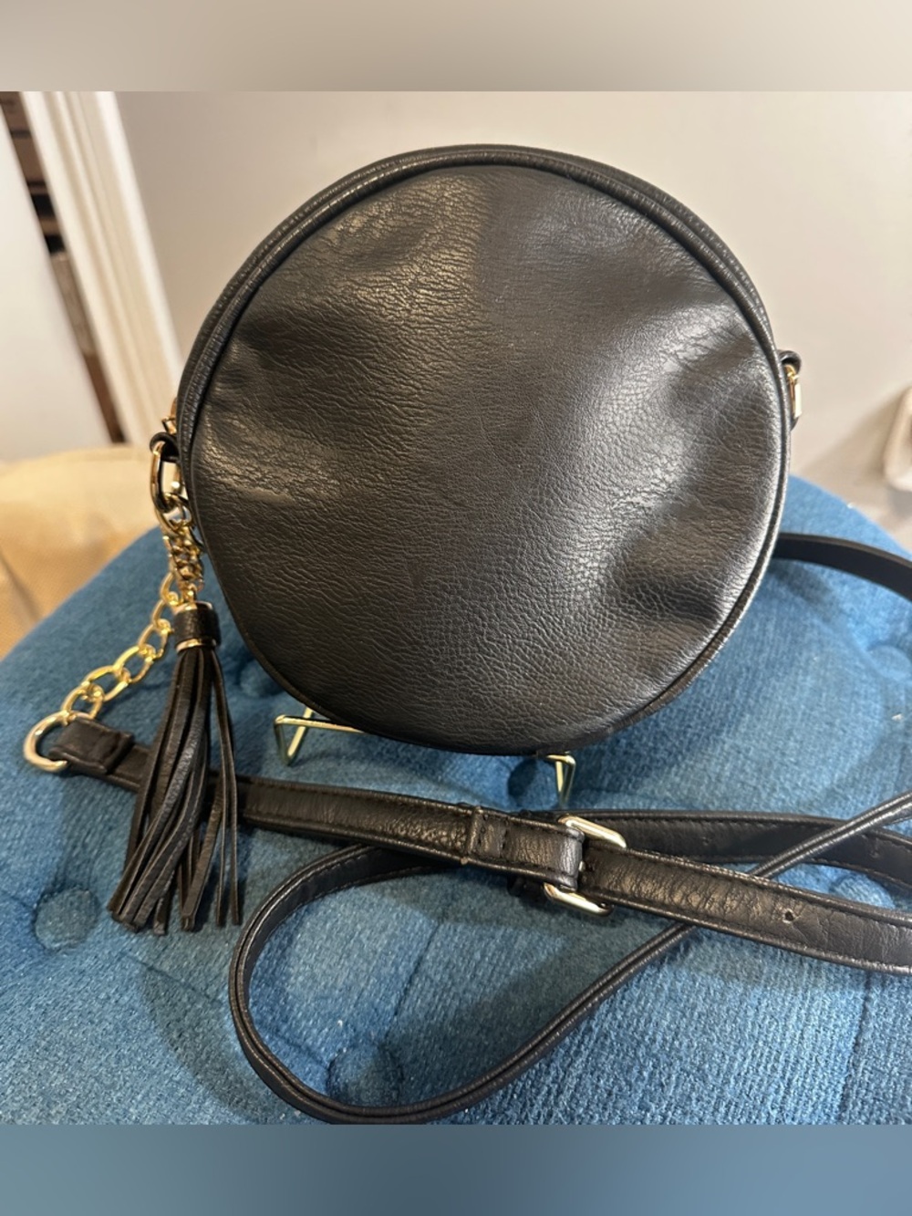 Round Black Crossbody Bag with Tassel Accent